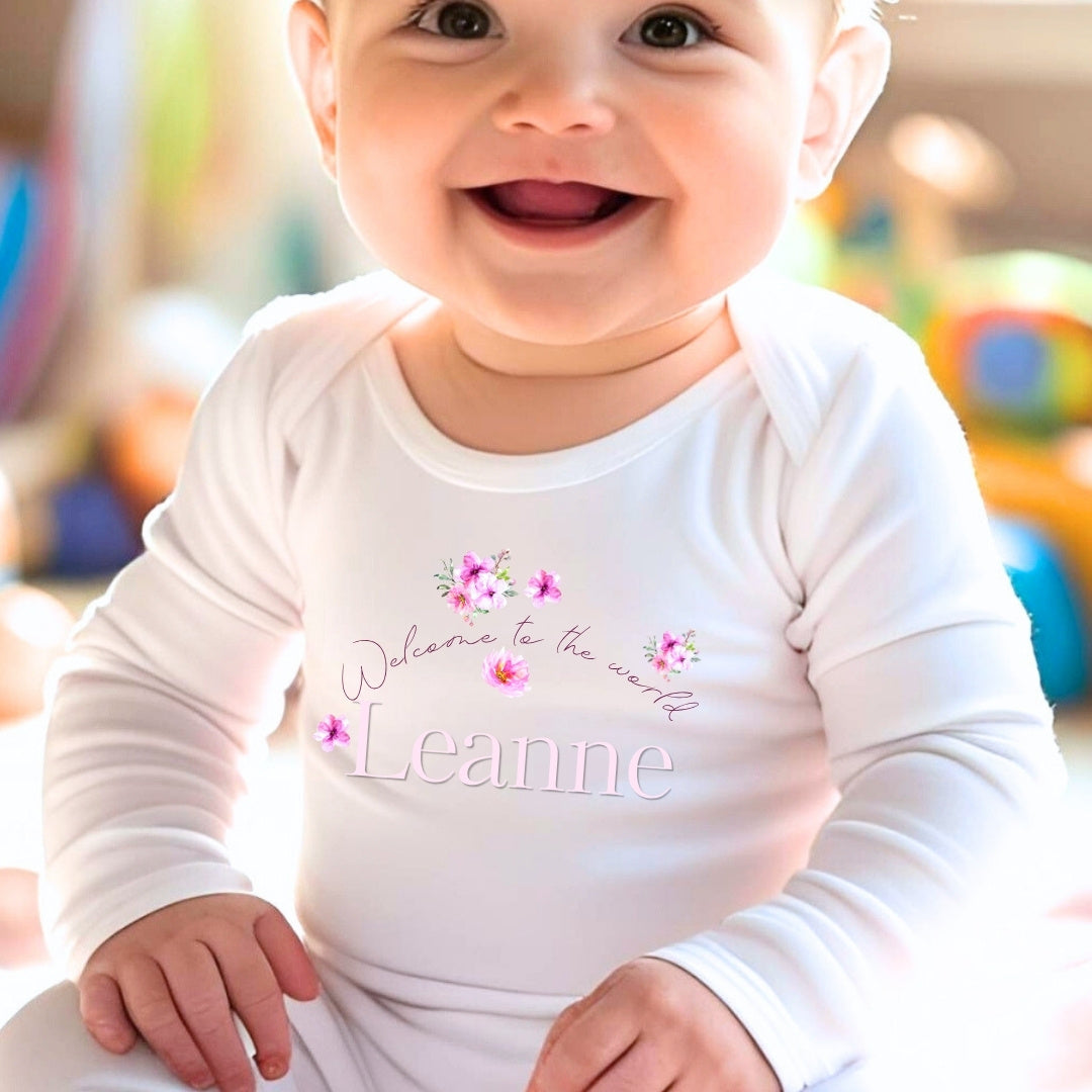 Personalised Pink Flowers Welcome to the World Baby Grow, Vest or Bib with Name